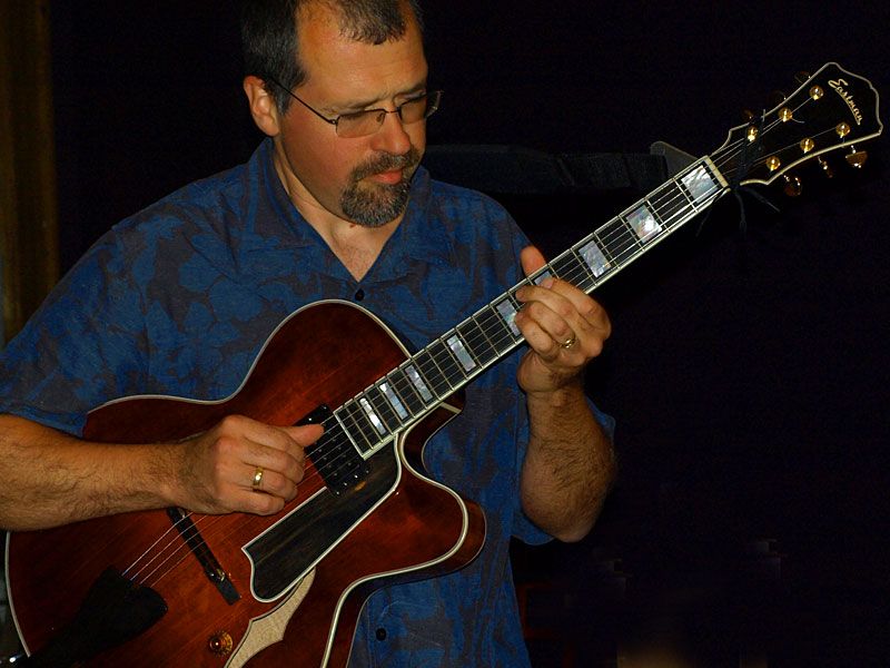 Justin Perdue playing an archtop jazz guitar